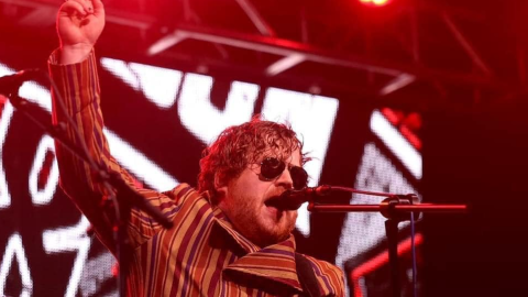 Guy Snowdon plays bass guitar and sings on stage