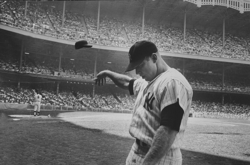 Yankee Mickey Mantle flinging his batting helmet away in disgust during bad day at bat, 1965