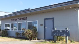 The exterior of the Bandon School District office slightly shaded on a sunny afternoon.