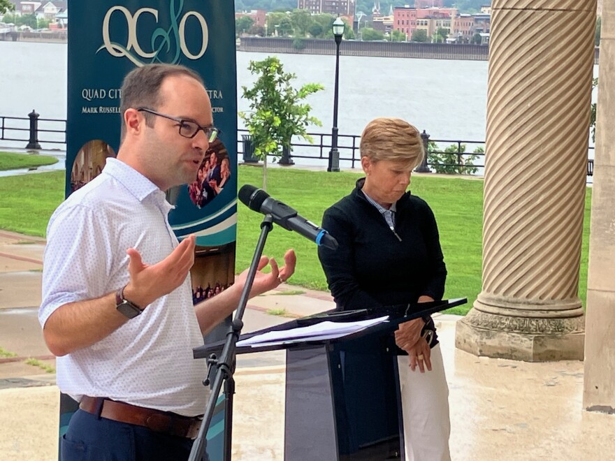QCSO executive director Brian Baxter discusses the impact of the bank sponsorship for Riverfront Pops, with QCBT president/CEO Laura Ekizian on Wednesday, Aug. 5, 2026 at LeClaire Park.