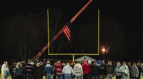 Students walk on the football field during a community prayer vigil, Tuesday, Nov. 14, 2023, at the Tuscarawas Valley Schools football stadium in Zoarville, Ohio.