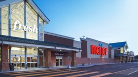 A Meijer supercenter as viewed from the front of the building. An entrance, bottle return and parking lot can be partially seen. 