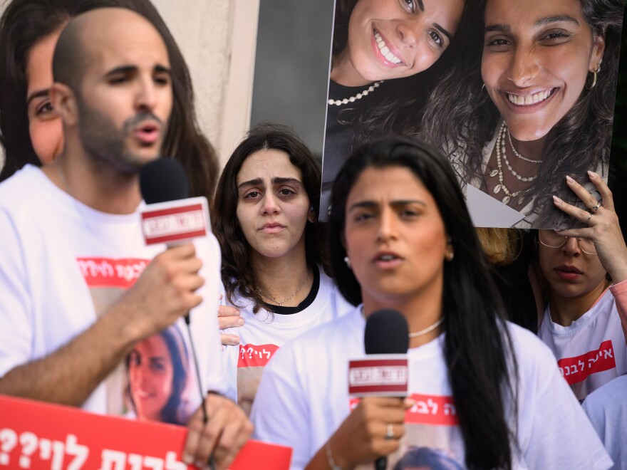 Family and friends of Livnat Levi, who was taken hostage by Hamas during an attack on Israel, hold up large photos of her as they are interviewed ahead of a press conference on Oct. 13, 2023 in Tel Aviv, Israel.