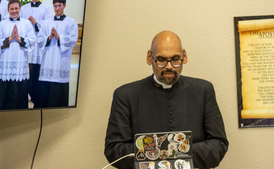 Father Ryan speaking to a group of youths about joining the priesthood at the Holy Family Catholic Church, photo by Alexander Brown.