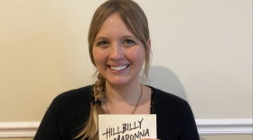 Poet Sara Moore Wagner holds a copy of her new book Hillbilly Madonna