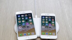 The AirPower wireless charger and iPhones are displayed in the showroom after the new product announcement at the Steve Jobs Theater on the new Apple campus in Cupertino, Calif.,  Sept. 12, 2017. (Marcio Jose Sanchez, File/AP)