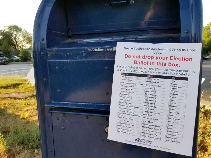 Photo of USPS mail box with an election sign telling voters not to drop ballots here.