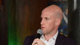 In this file photo, sportswriter Grant Wahl speaks during a panel discussion in New York in 2014. He died Friday in Qatar while covering the Argentina-Netherlands World Cup quarterfinal.