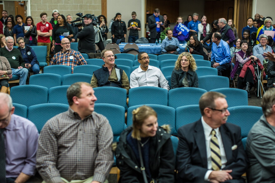 Three undecided Democratic caucus-goers (C) attend a party caucus in West Des Moines, Iowa in February 2016. 