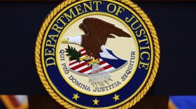 FILE - The U.S. Department of Justice logo is seen on a podium before a press conference, May 6, 2025, at the Justice Department in Washington. (AP Photo/Julia Demaree Nikhinson, File)