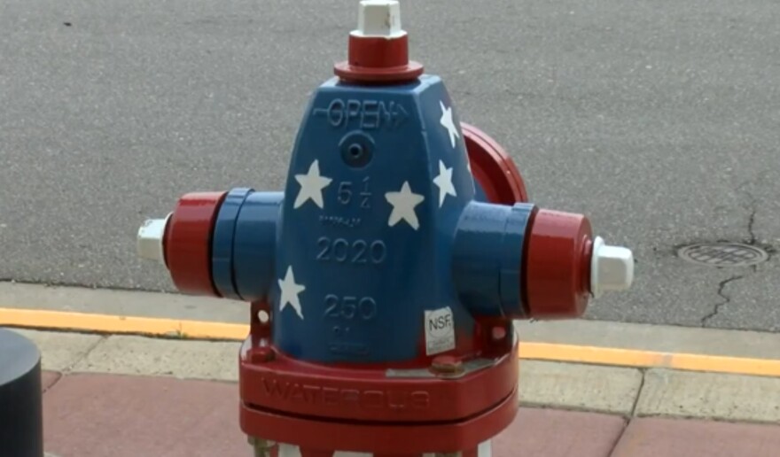Fire hydrants in Antigo being given patriotic paint jobs