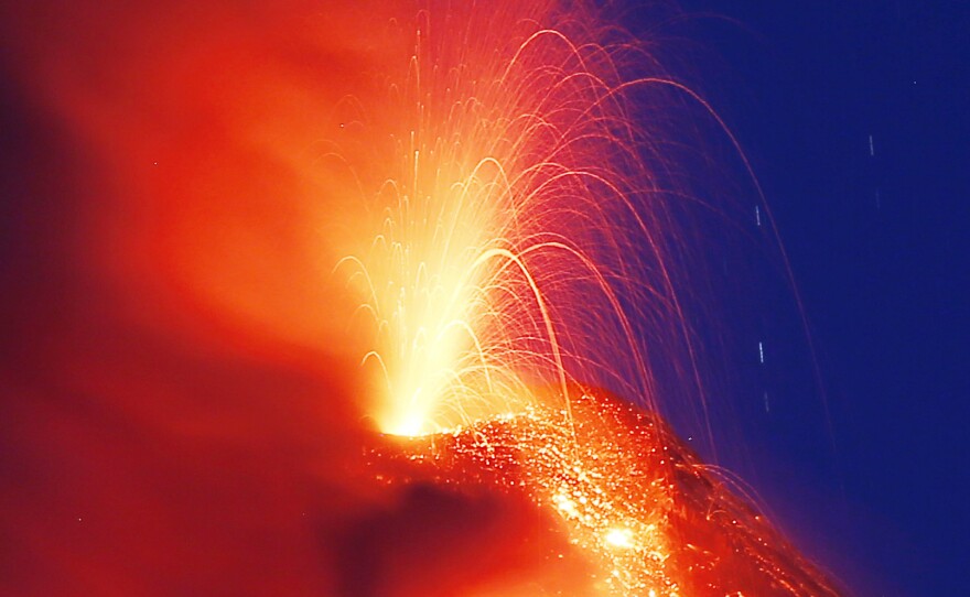 Mayon volcano erupts for the second straight day as lava cascades down its slopes on Tuesday, as seen from Legazpi city, Albay province.