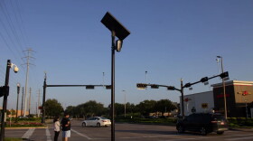 A Flock Safety camera towers above an intersection in Sugar Land, Texas.