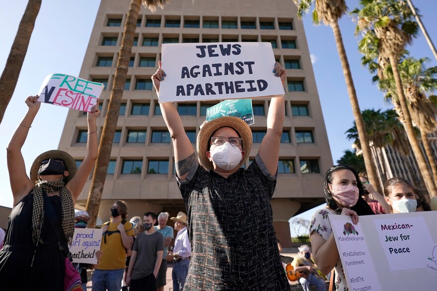 People hold a rally Monday in Tucson, Ariz., in support of Palestinians.