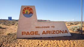 Beige sign with boat image and text: Welcome to Page, Arizona