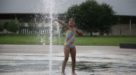 A child plays in the Liz Carpenter Fountain. The fountain will be closed until May so city crews can upgrade the filtration system.