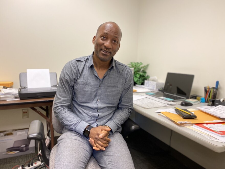 Nsiona Nguizani, cultural broker for the town of Brunswick, in his office. Nguizani, who is also the president of the Angolan Community of Maine, said he wants to help as many asylum seekers as possible find long-term housing in the Brunswick area. (Ari Snider)