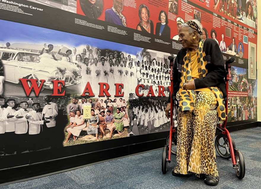 Miami Civil Rights pioneer Thelma Gibson spots a photo of herself in the history wall immortalizing alumni from George Washington Carver Elementary.