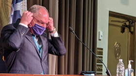 Louisiana Gov. John Bel Edwards adjusts his mask after his a coronavirus media briefing. October 22, 2020.