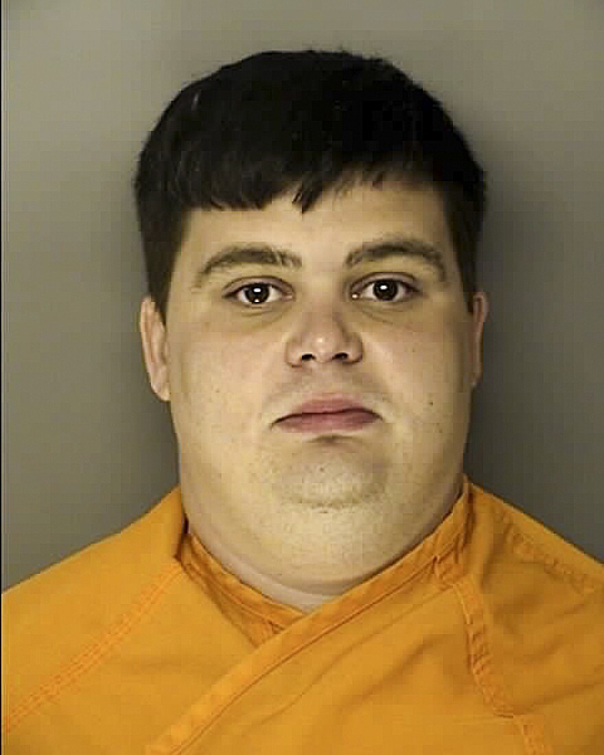 Benjamin Thomas Samuel McDowell, seen in a booking photo, is charged with being a felon in possession of a firearm. He allegedly said he wanted to commit an attack in the "spirit of Dylann Roof."