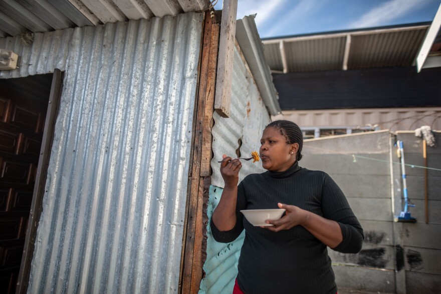 Aviwe Maphini, 30, eats pasta with canned sardines in front of her home in Cape Town, South Africa. The mom of two was working as a lawyer before the pandemic hit. When she lost her job, she says, "The first thing I thought of was my kids."