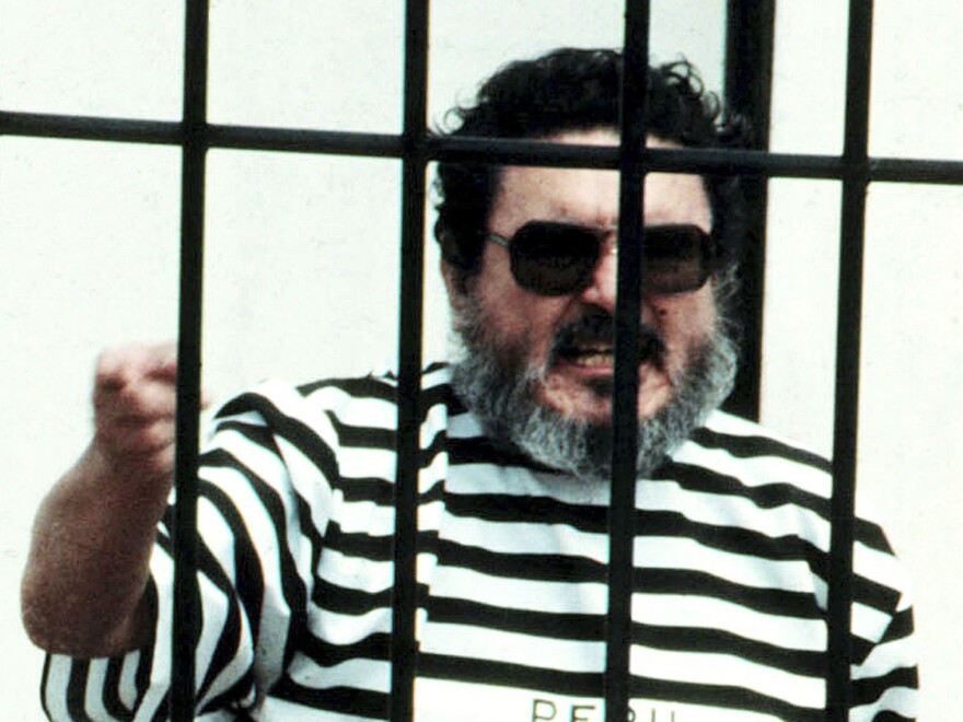 In this Sept. 1992 file photo, Abimael Guzmán, the founder and leader of the Shining Path guerrilla movement, shouts inside of a jail cell after being captured in Lima, Peru. The Peruvian government reported Saturday that Guzman died after an illness.