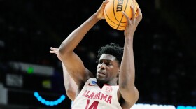 FILE - Alabama center Charles Bediako (14) pulls down a rebound while guarded by Maryland guard Ian Martinez, left, during the second half of a second-round college basketball game in the men's NCAA Tournament in Birmingham, Ala., March 18, 2023. (AP Photo/Rogelio V. Solis, File)
