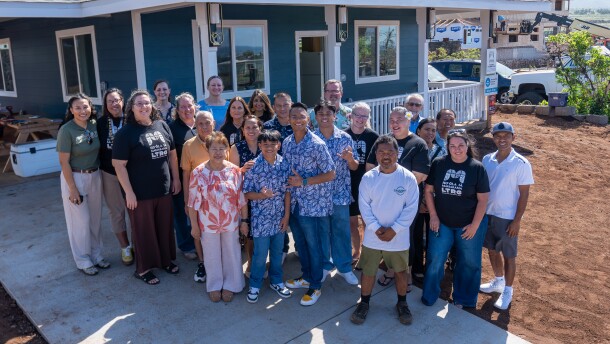 The Yadao family (center) at their rebuilt Lahaina home, with Mennonite Disaster Services volunteers and Hoʻōla iā Mauiakama Disaster Long Term Recovery Group staff that helped them rebuild.