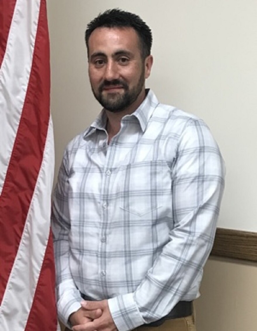 Sam Downs posing next to U.S. flag