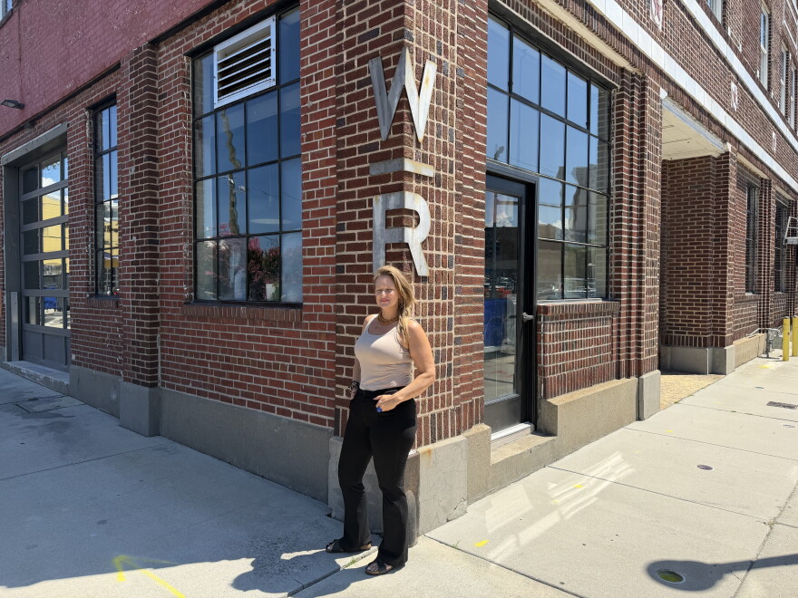 Careyann Weinberg, former director of Work|Release, outside the Texaco building in Norfolk's NEON District under the venue's original signage.