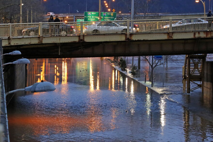 The Allegheny River overflows its banks, flooding Duquesne Boulevard in downtown Pittsburgh, Friday, Feb. 16, 2018.
