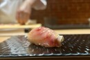 A piece of sushi on a plate. 