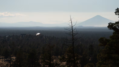FILE - A house sits atop a hill in Redmond, Ore., as wildfire smoke from the Akawa Butte Fire, burning just north of Sisters, lingers in the air on July 24, 2026.