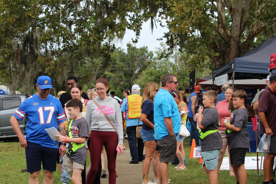 Visitors walk through the vendor booths at the Central Florida Peanut Festival in Heritage Park in Williston on Saturday, Oct. 3, 2026. (Hailey Hoffmann/WUFT News)