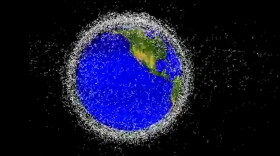 A NASA rendering shows satellites and space debris orbiting Earth.