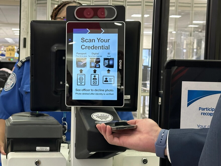 person scans mobile id from phone at TSA checkpoint
