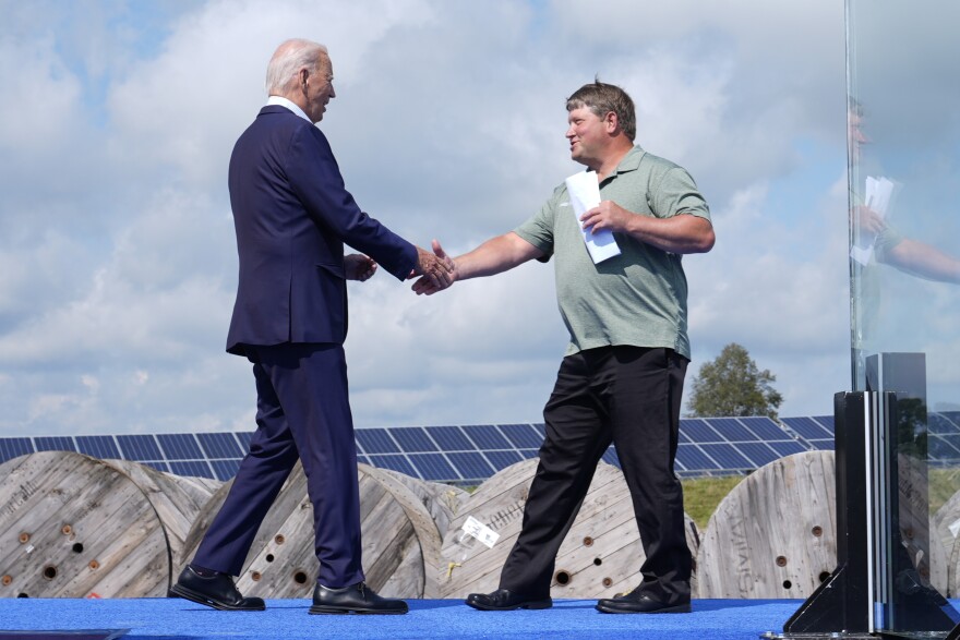 President Joe Biden, left, shakes hands with Darin Von Ruden, President of District Five of the Wisconsin Farmers Union, before speaking during a visit to Vernon Electric in Westby, Wis., Thursday, Sept. 5, 2024. Biden is in Wisconsin to promote his Investing in America agenda.