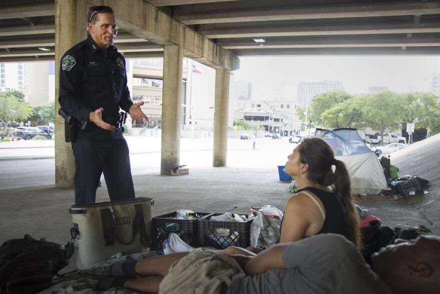 Assistant Austin Police Chief Justin Newsom speaks with Tanya Bullman and James McPherson