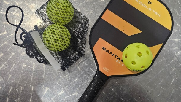 A representative image of pickleball bat and ball