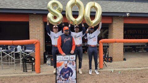 Keystone College baseball Coach Jamie Shevchik poses with three of his players after the Giants won 10-8 on Friday afternoon, earning the coach his 800th victory.