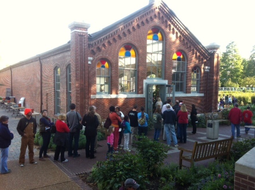 People line up outside the Linnean House at the Missouri Botanical Garden to see, and smell, the corpse flower.