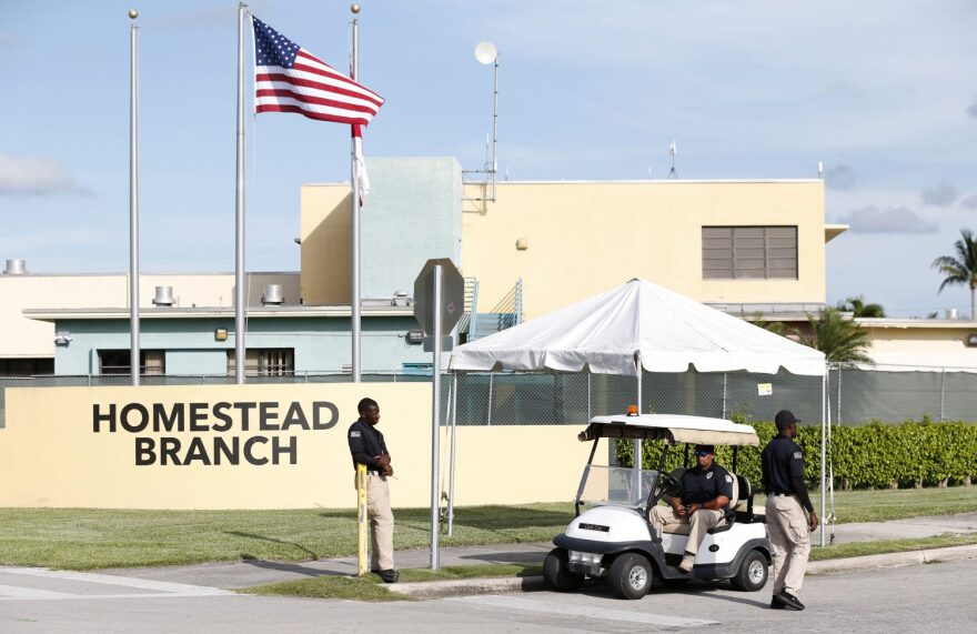 Security guards stand outside a former Job Corps site that now houses child immigrants, Monday, June 18, 2018, in Homestead, Fla. It is not known if the children crossed the border as unaccompanied minors or were separated from family members. (AP Photo/Wilfredo Lee)