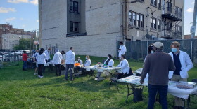 Students at the Medical College of Wisconsin host an outdoor health clinic during the coronavirus pandemic in 2021. Now, there's another outbreak in the state for which a vaccine already exists.