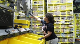 A worker sorts through items and places orders at the Amazon Fulfillment Center in Staten Island in New York. 