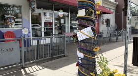 A tree covered in decorations on a sidewalk
