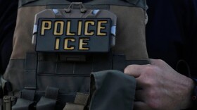 A U.S. Immigration and Customs Enforcement agent takes part in an early morning operation in Park Ridge, Ill., Sept. 19, 2025.