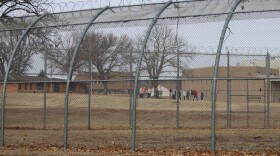 A group of people walking at the Kansas Juvenile Correctional Complex. 