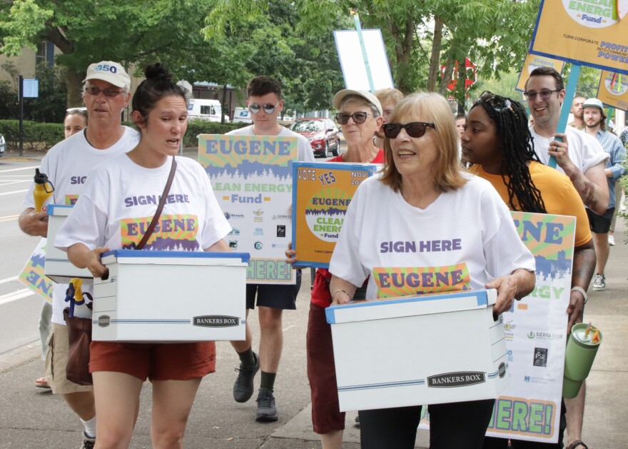 Eugene Clean Energy Fund supporters march through downtown Eugene.