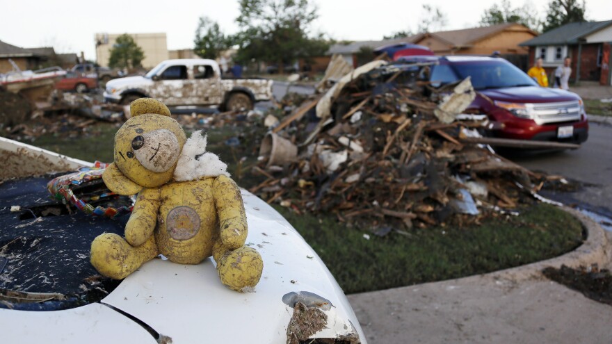 A teddy bear sits atop some of the rubble in Moore, Okla.