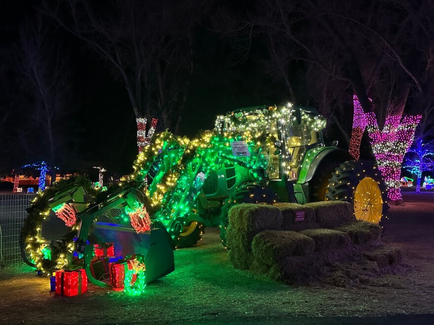 Green tractor wrapped in lights at Washington Park 